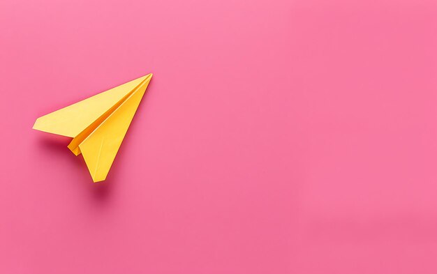 a paper airplane is on a pink background with a yellow triangle on the left