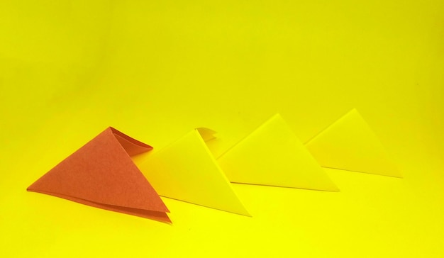 Paper arrow concept of leadership and success business concept on a yellow background new idea courage new thinking creative solution