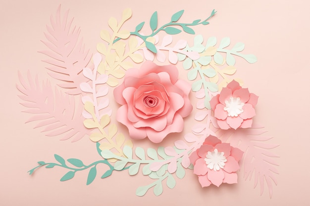 Paper art pink background with flowers and tropical leaves. Fashion floral greeting card.