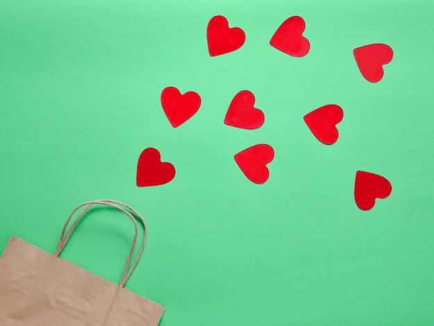 A paper bag for shopping and lots of decorative hearts
