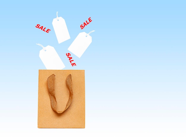 Paper bag and white empty tags on a blue background.\
levitation