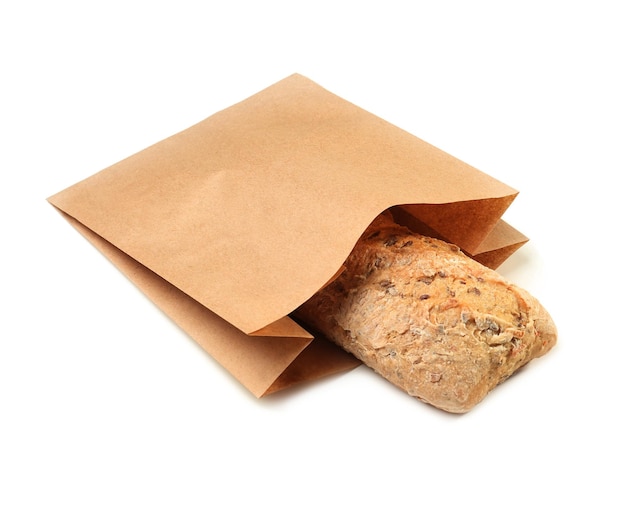Paper bag with bread on white background Space for design