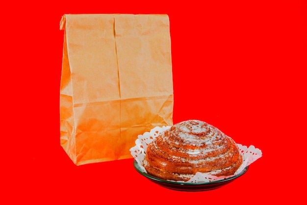 Paper bag with bun on a red background