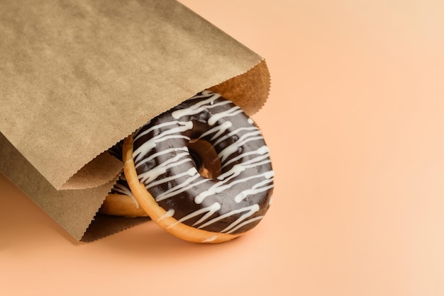 Paper bag with chocolate donuts closeup