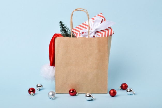 A paper bag with Christmas gifts and decorations. Preparation for the New year and Christmas. Delivery.