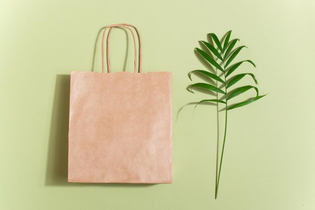 A paper bag with green live leaves.