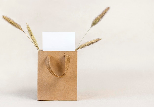 Photo paper bag with white clean paper and dried flowers