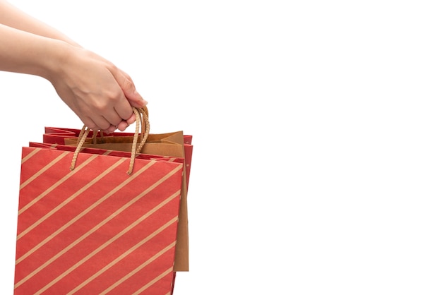 Paper bag in woman hands isolated on white 