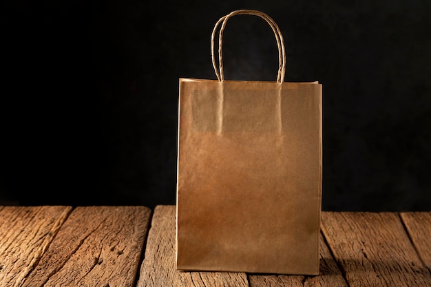 Paper bag on wooden table. Texture for black friday.