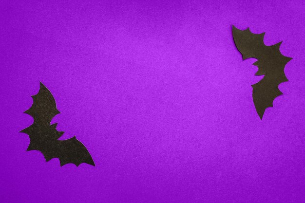 Paper bats on a purple background halloween concept