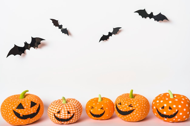 Paper bats over toy jack-o-lanterns