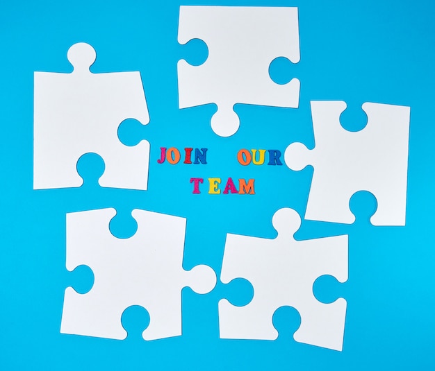 Paper blank white puzzle on a blue background, the inscription join our team