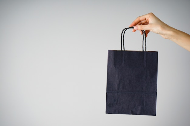 Paper blue bag in a female hand