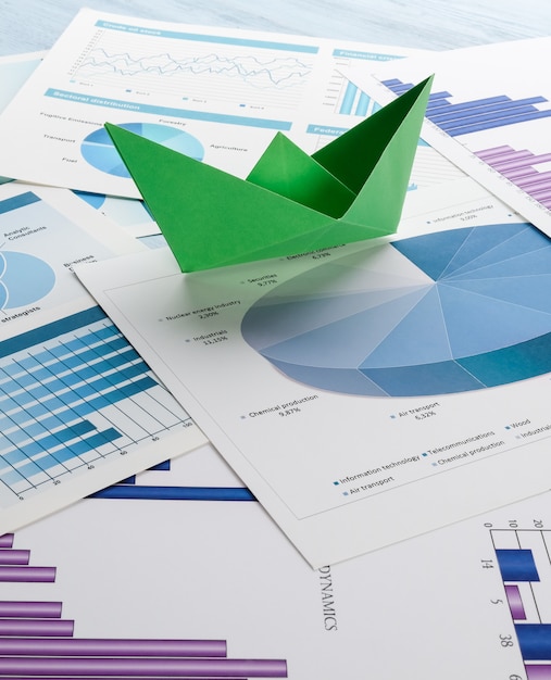 Photo paper boat on business charts