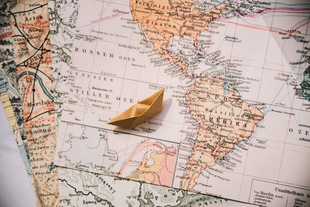 Paper boat on maps