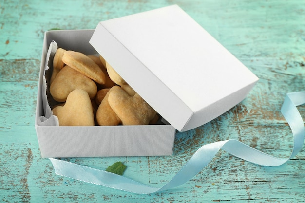 Photo paper box with butter cookies on wooden background