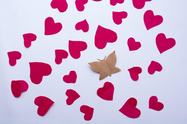 Paper butterfly and paper hearts in red color