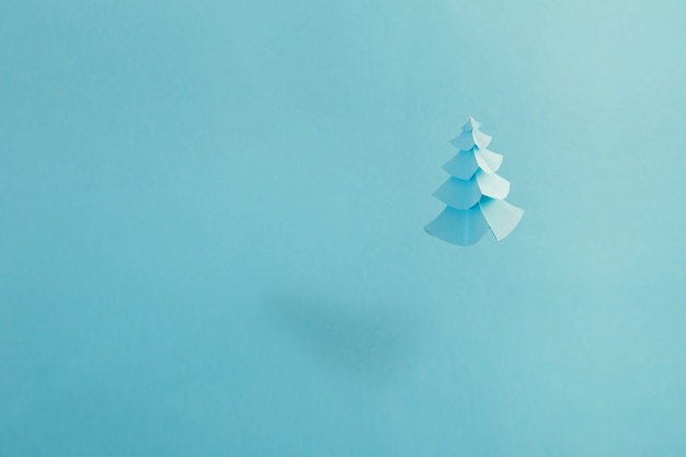 Paper Christmas tree on blue background