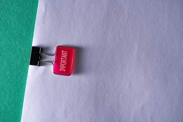 Paper clip with single word important on blank paper