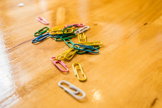 paper clips on a wood table. organize the office.