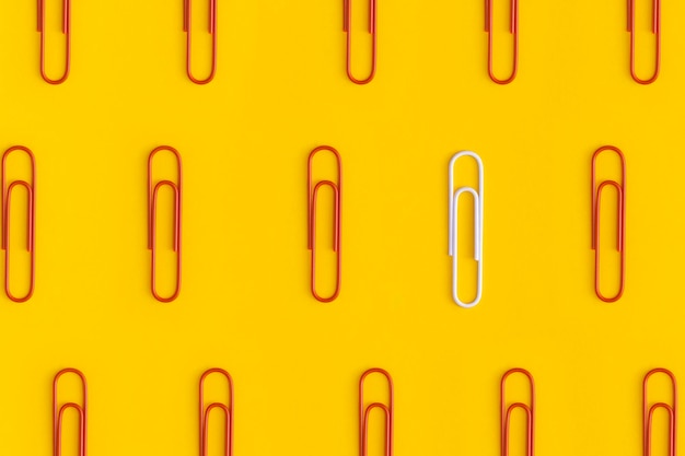 Paper clips on yellow background Top view Flat lay Leadership concept