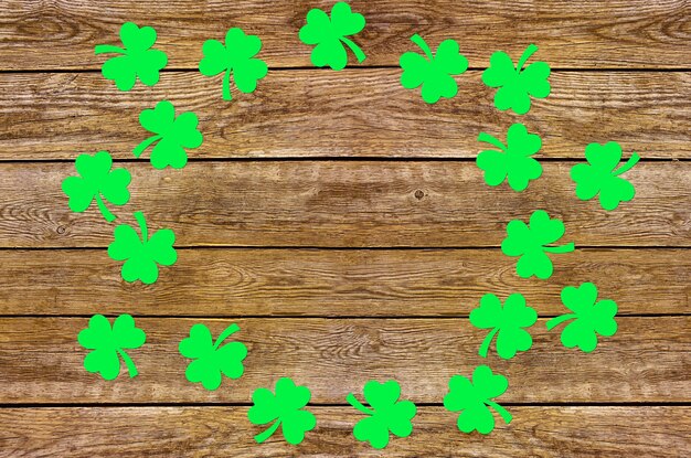 Paper clover leaves on the old wooden