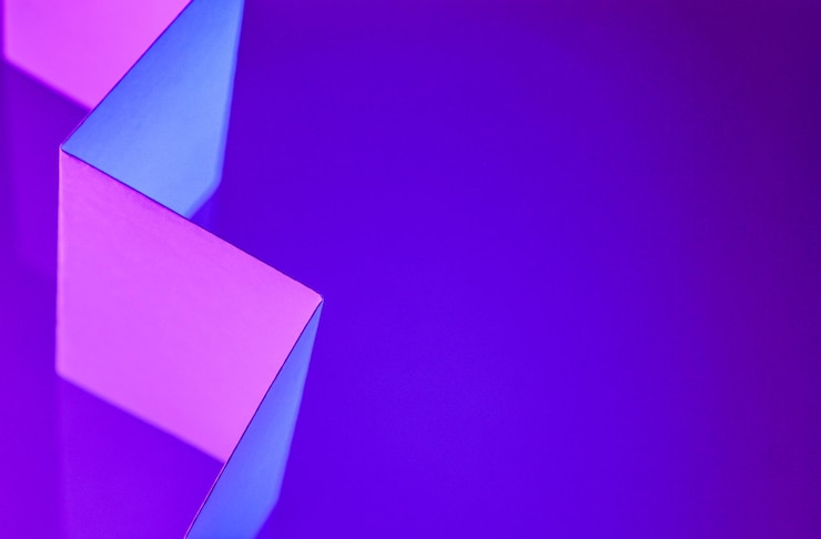 Photo paper colored with blue and purple light as an abstract background