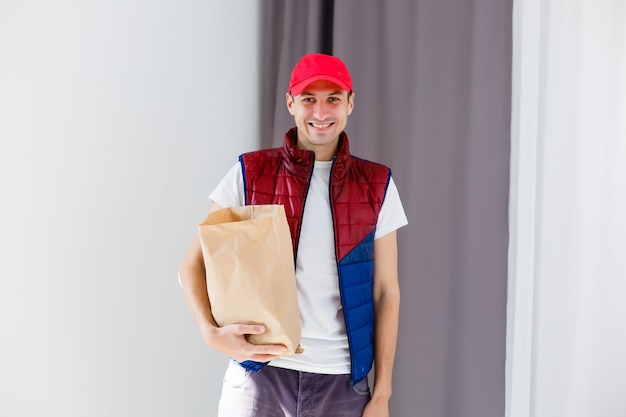 Paper container for takeaway food. Delivery man is carrying