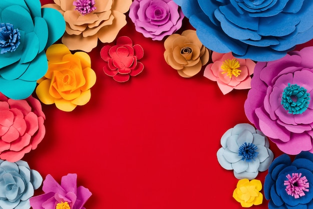 Paper craft flowers on red table