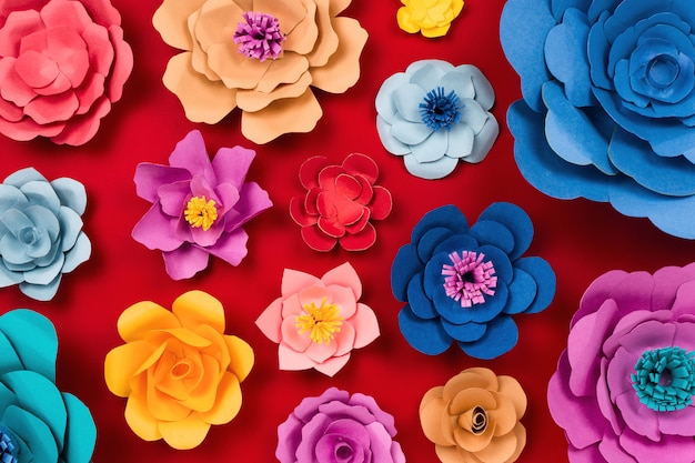 Paper craft flowers on red table