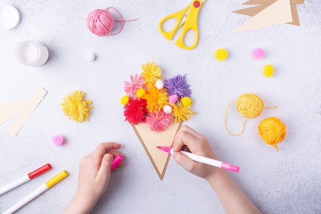 Mestieri di carta per la festa della mamma marzo o compleanno bambino piccolo che fa un mazzo di fiori di carta colorata e palline colorate per maglieria per la mamma semplice idea regalo vista dall'alto spazio copia foto di alta qualità