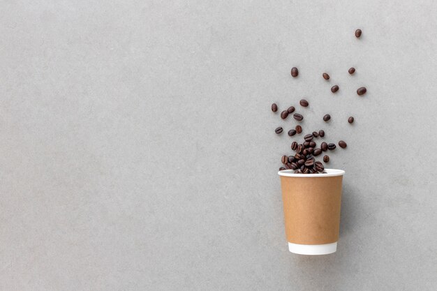 Paper cup and coffee beans