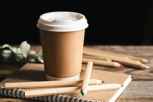 Paper Cup of coffee wooden colored Pencils made from natural materials and recycled Notebook