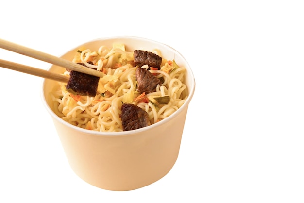 Paper cup with instant ramen noodles with beef and vegetables isolated on white background.