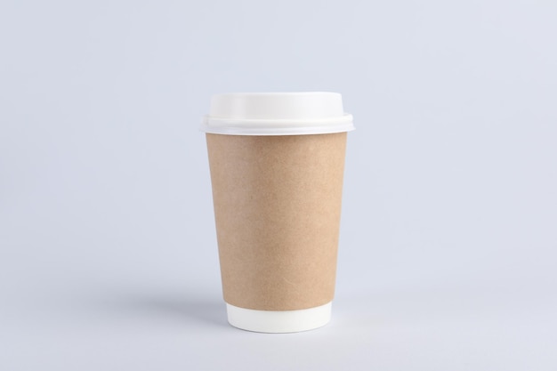 Paper cup with plastic lid on light background Coffee to go