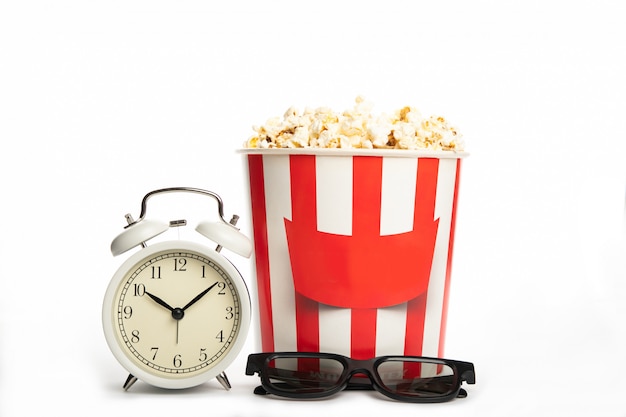 Photo paper cup with popcorn, 3d glasses and an alarm clock