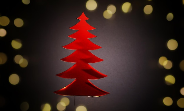 Photo paper cut christmas tree with bokeh lights