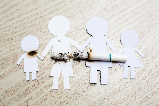 Paper cut of family destroyed by cigarettes Drugs destroying family concept World no tobacco day