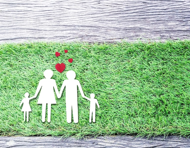 Paper cut of family on grass top view