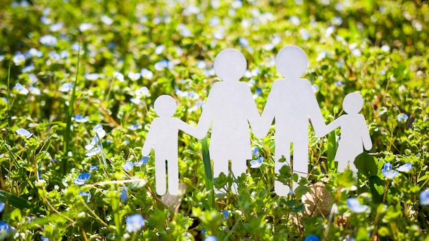 Paper cut family on green grass