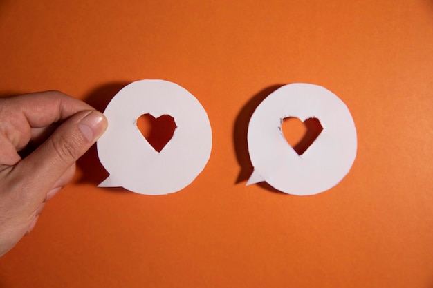 Paper cut heart on the orange and blue background