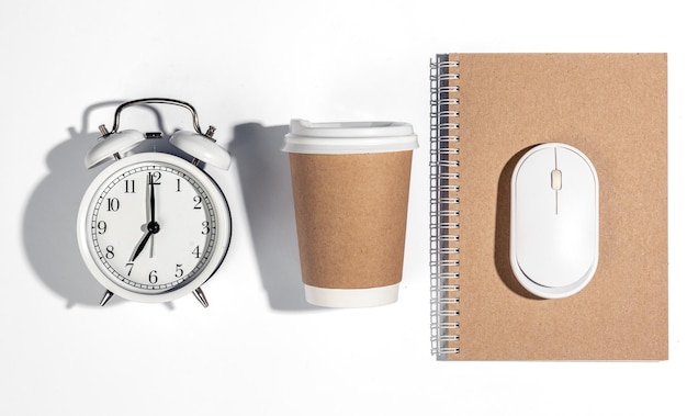 Paper disposable cup alarm clock and computer mouse on a white background