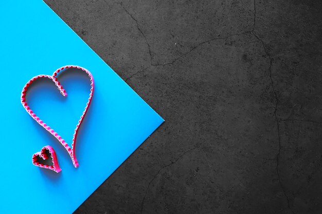 paper elements in shape of heart on dark stone background. love and valentine's day concept. birthday greeting card design.