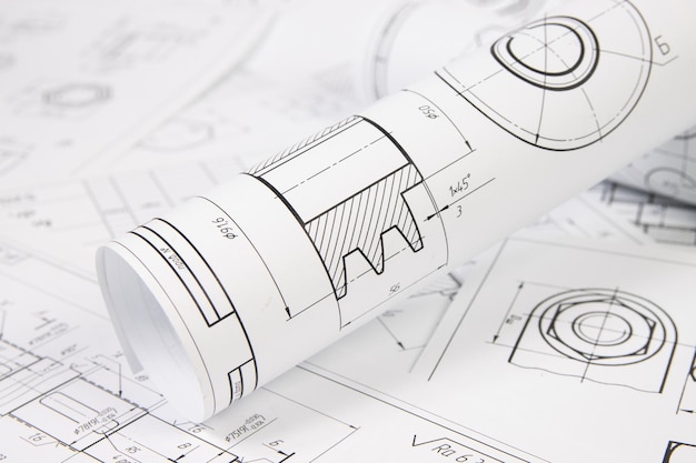 Paper engineering drawings of industrial parts and mechanism