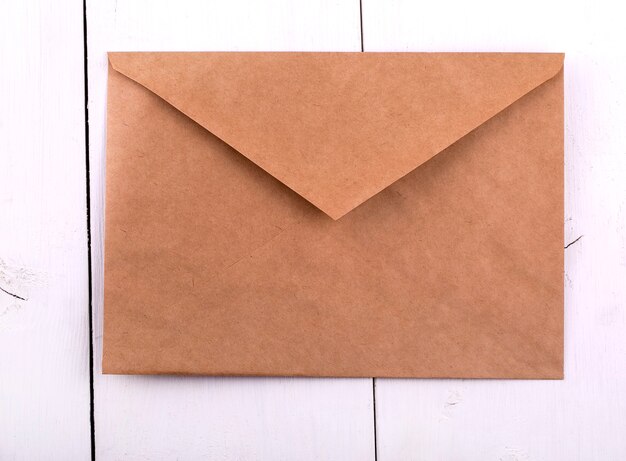 Paper envelope on a white wooden table.