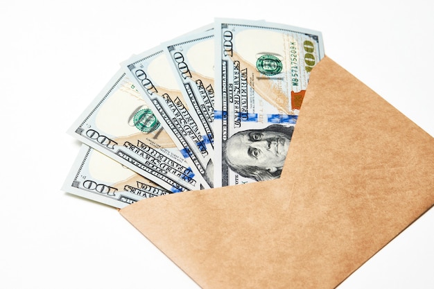 Paper Envelope with money, close-up. Dollar money in an envelope isolated on white. Salary, earning and savings concept