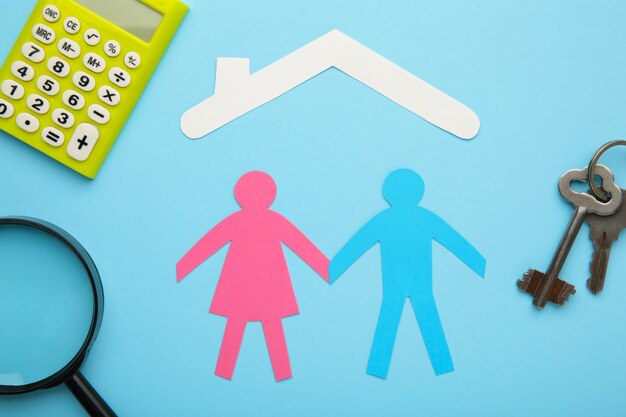 Paper family and house on blue background. Insurance concept.