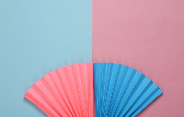 Photo paper fans on bluepink pastel background concept art minimalism