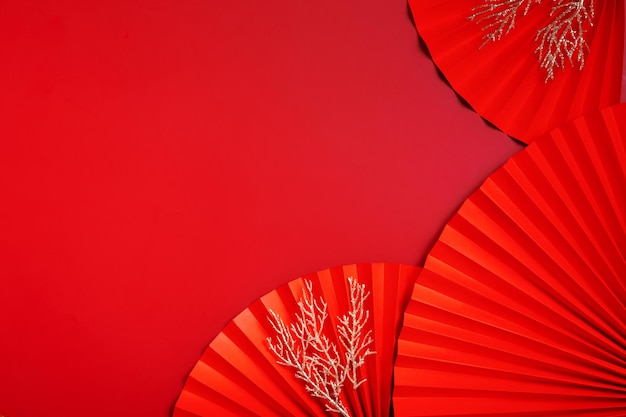 Paper fans symbol Chinese new year top view with copy space Monochrome red background