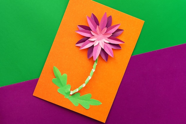 Paper flower craft by child flat lay
